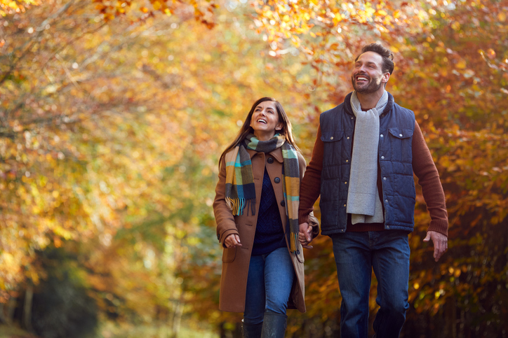 A couple walking together outdoors.